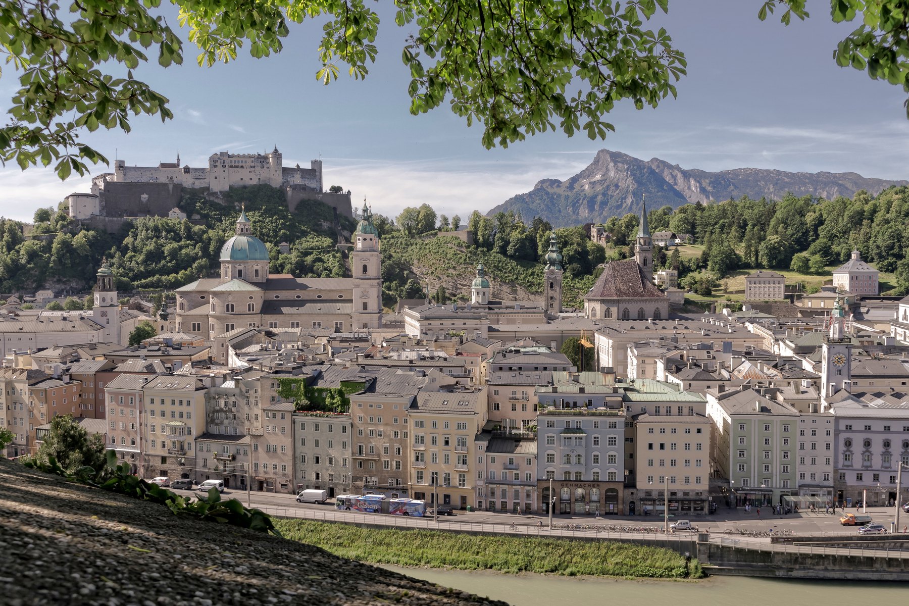 The old town and the fortress from the Kapuzinerberg, mountains behind